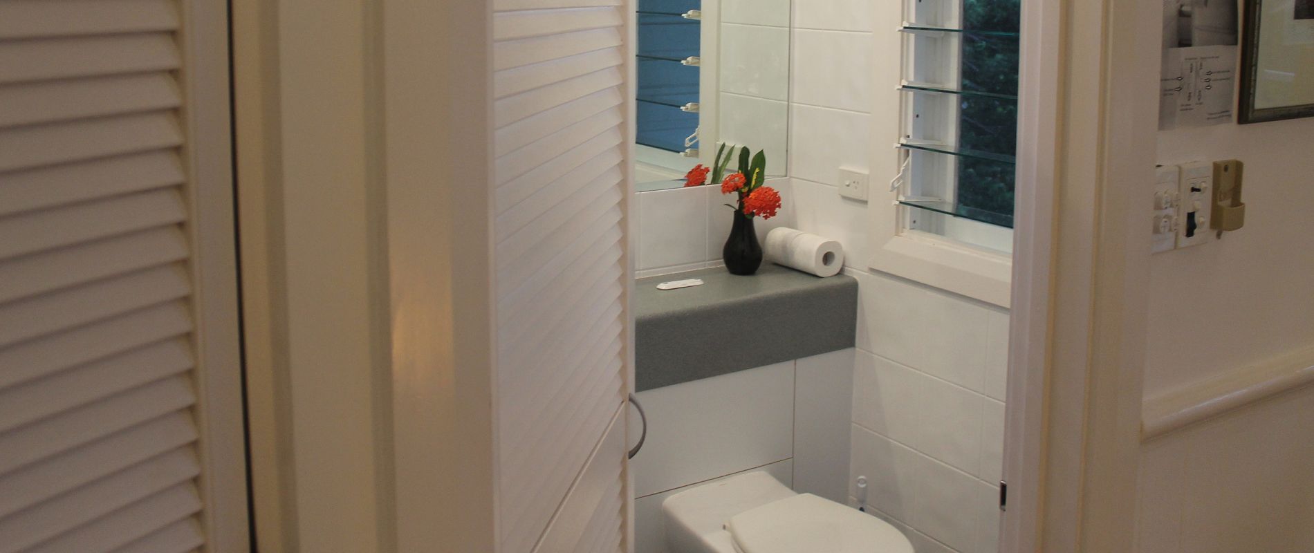 Modern bathroom with a view Modern studio bathroom with shower and windows overlooking natural tropical views