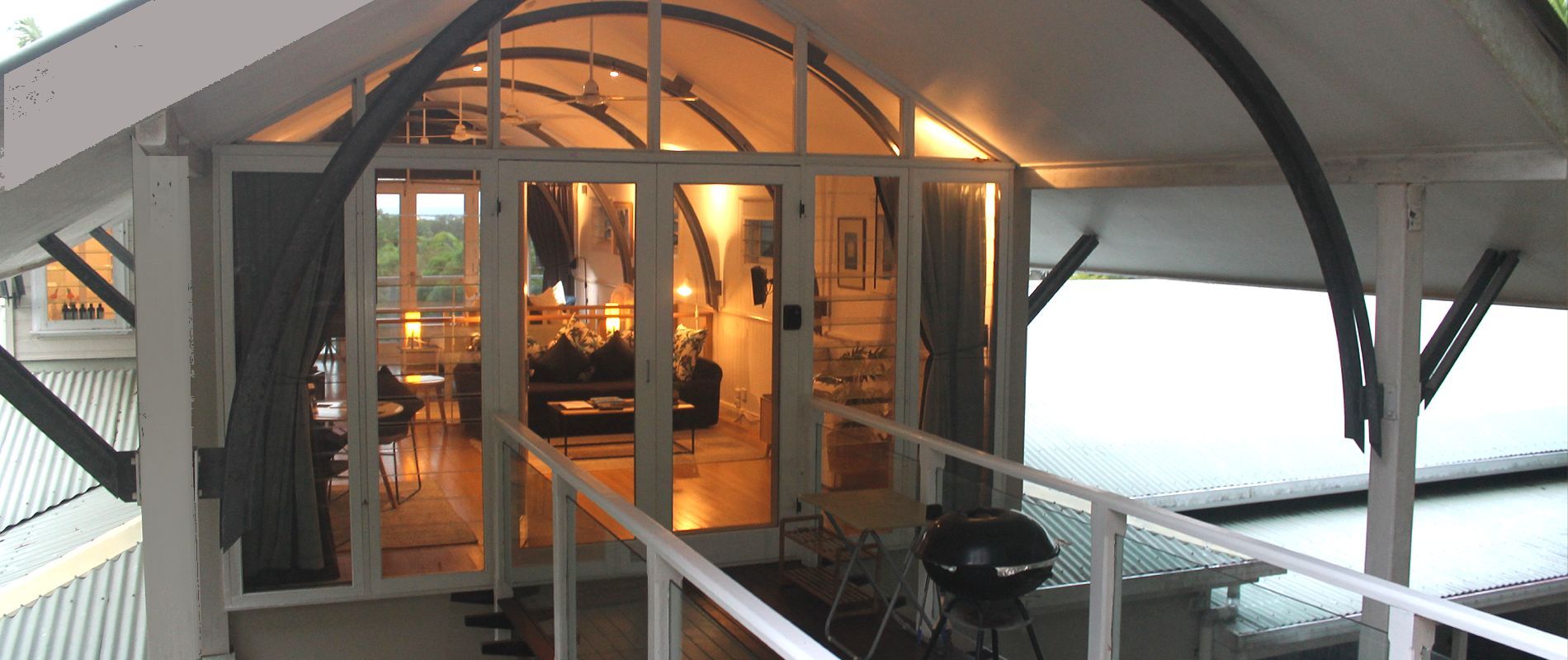 Studio deck walkway and entrance Private deck walkway leading to dramatic glass-walled entrance of luxury studio