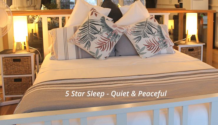 Comfortable queen size bed in the 5-star rated luxury Oak Beach studio suite